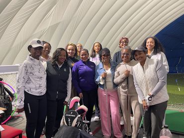 Members gathered at an indoor golf simulator session
