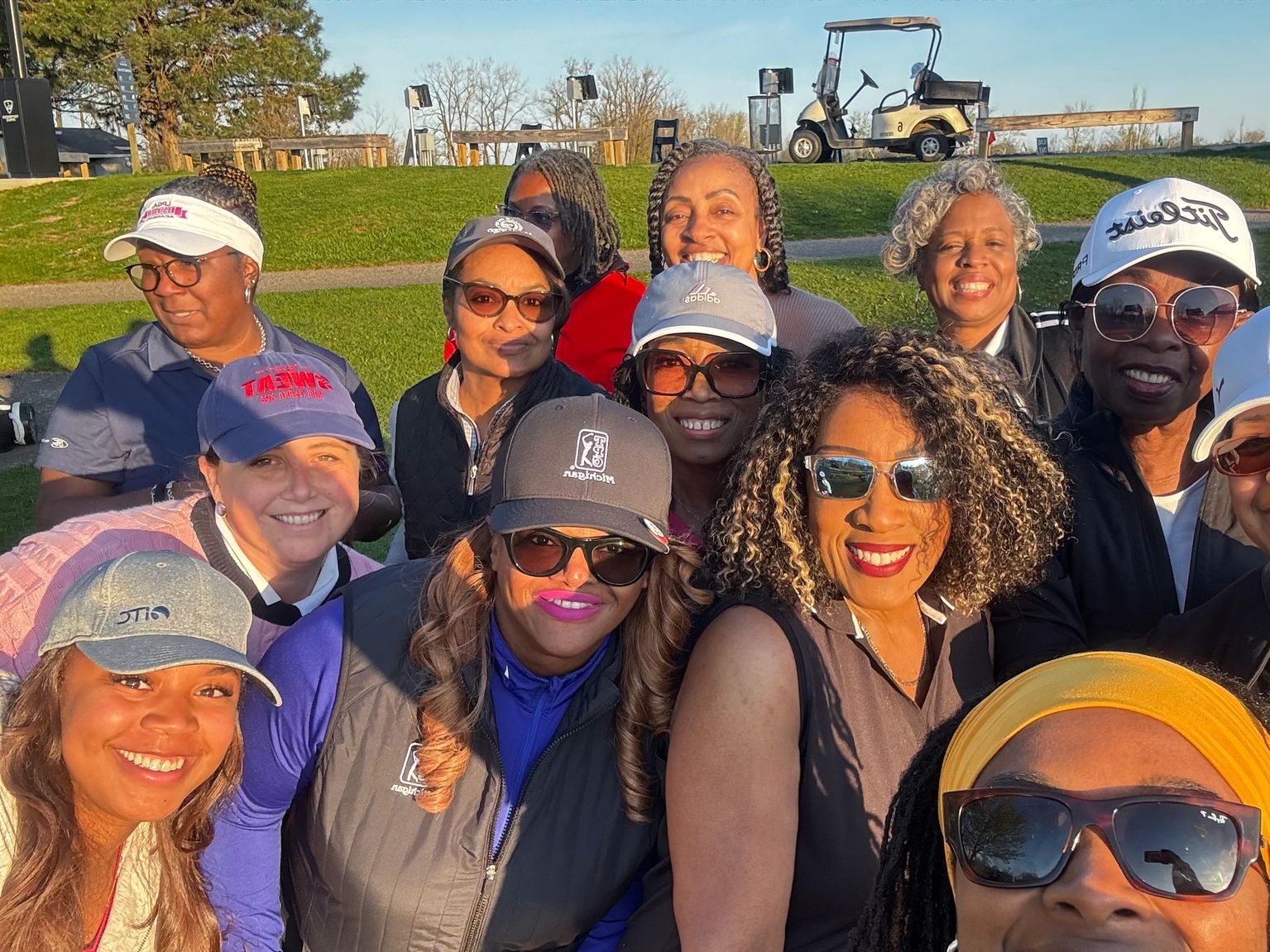 The collective together on the course at golden hour